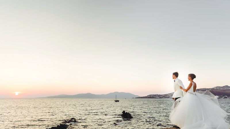 look-from-afar-at-lovely-wedding-couple-watching-the-sunset-over-the-sea.jpg